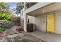 Back porch with painted yellow door featuring a 