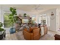 Comfortable living room with a large bookcase, leather sofa, and bright windows at 3777 Peachtree Ne Rd # 1227, Brookhaven, GA 30319