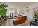 Inviting living room featuring a leather sofa, ceiling fan, and a serene ambiance at 3777 Peachtree Ne Rd # 1227, Brookhaven, GA 30319