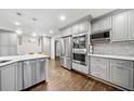 Modern kitchen with stainless steel appliances, sleek gray cabinets, and hardwood flooring at 1315 Merry Ne Ln, Atlanta, GA 30329
