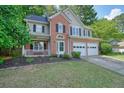 Inviting two-story home with brick accents, a well-kept lawn, and a two-car garage at 3366 English Oaks Nw Dr, Kennesaw, GA 30144