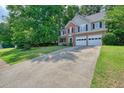 Spacious two-story home with a long driveway and a mix of brick and siding exterior at 3366 English Oaks Nw Dr, Kennesaw, GA 30144