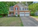 Beautiful two-story home boasts a brick front, large windows, and a lush green lawn at 3366 English Oaks Nw Dr, Kennesaw, GA 30144