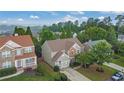 Aerial view of a well-maintained neighborhood with lush trees and manicured lawns at 202 Roseman Way, Woodstock, GA 30188