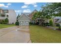 Charming two-story home with lush landscaping, a two-car garage, and a welcoming front entrance at 202 Roseman Way, Woodstock, GA 30188