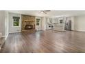 Spacious living room featuring wood floors, a stone fireplace, and an open layout to the kitchen at 2067 Skyhawk Ln, Acworth, GA 30102