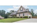 Attractive home with a mix of stone and siding, complemented by a well-groomed lawn and driveway at 2118 Braswell Ln, Loganville, GA 30052