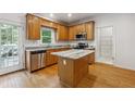Well-lit kitchen features granite countertops, stainless appliances, and an island at 2335 Corbett Ct, Powder Springs, GA 30127