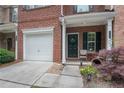 Charming porch featuring a front door with a wreath, seating, and beautiful landscaping at 2377 Heritage Park Nw Cir # 16, Kennesaw, GA 30144