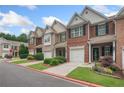 A street view showcasing townhomes, well-maintained lawns, and paved walkways in a residential neighborhood at 2377 Heritage Park Nw Cir # 16, Kennesaw, GA 30144