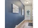 Modern entryway with beautiful hardwood flooring, blue accent wall, and elegant decor at 1181 Chastain Dr, Sugar Hill, GA 30518