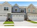 Inviting townhome showing a garage, well-manicured lawn, and beautifully colored siding at 1181 Chastain Dr, Sugar Hill, GA 30518