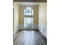 Dining room featuring a large chandelier and wainscotting at 4460 Greycliff Pte, Douglasville, GA 30135