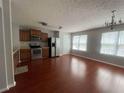 Traditional kitchen featuring stainless steel appliances, and wood laminate flooring at 6361 Redan Sq, Lithonia, GA 30058