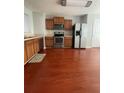 Traditional kitchen featuring stainless steel appliances, and wood laminate flooring at 6361 Redan Sq, Lithonia, GA 30058