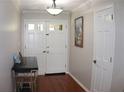 Bright entryway featuring double front doors, hardwood floors, and neutral wall paint at 1310 Larkview Sw Dr, Lilburn, GA 30047