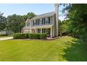 Attractive two-story home with a chimney, manicured bushes, and a well-kept front lawn at 305 Hickory Pointe Ct, Villa Rica, GA 30180