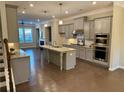 Modern kitchen featuring stainless steel appliances, granite counters, island, and hardwood floors at 531 Headwind Way, Alpharetta, GA 30005
