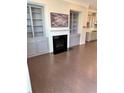Inviting living room featuring a fireplace and built-in bookshelves at 531 Headwind Way, Alpharetta, GA 30005