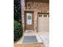 Inviting front door with stone accents, a decorative wreath, and a 'Welcome' mat near the garage at 3235 Chutney Ct, Avondale Estates, GA 30002