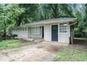 Charming single-story home with a brick foundation and a partially-wooded lot at 4009 Kirksford Dr, Decatur, GA 30035