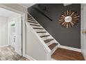 Elegant staircase featuring wood and white accents, leading to the upper level with modern design elements at 4113 Ashford Green Dr, Duluth, GA 30096