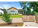 Bungalow exterior with beautiful yard and landscaping, decorative fence, and driveway gate at 853 Gaston Sw St, Atlanta, GA 30310