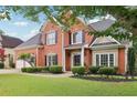 Beautiful brick home with a well-maintained lawn, black shutters, and manicured bushes offering great curb appeal at 2009 Mclain Nw Rd, Acworth, GA 30101