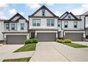 Beautiful townhome with a grey two-car garage, well-kept lawn, and attractive curb appeal at 320 Crider Ct, Woodstock, GA 30188