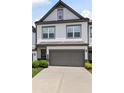 The exterior features a two-car garage and manicured landscaping at 320 Crider Ct, Woodstock, GA 30188