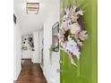 Welcoming entryway with a bright green door, stylish wreath, and hardwood floors at 1151 Bromley Rd, Avondale Estates, GA 30002
