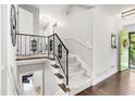 Elegant staircase with wrought iron railing and light-filled landing in a home at 1151 Bromley Rd, Avondale Estates, GA 30002