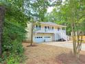 Charming two-story home with a spacious porch and a two-car garage, surrounded by lush greenery at 294 Spring Leaf Dr, Dallas, GA 30157