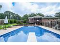 Large backyard swimming pool featuring a diving board and outdoor seating and deck at 879 Old Tucker Rd, Stone Mountain, GA 30087