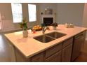 This kitchen island has a light countertop, cabinets, stainless steel sink, and stainless steel dishwasher at 1783 Shetley Creek Drive, Norcross, GA 30071
