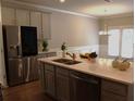 This kitchen features a stainless steel refrigerator and a center island with a sink and a light countertop at 1783 Shetley Creek Drive, Norcross, GA 30071