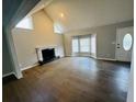 Bright living room with hardwood floors, fireplace, and a bay window with natural light at 208 Arbour Way, Suwanee, GA 30024