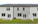 Townhome backyard featuring a patio area, green lawn, and privacy fencing at 321 Sound Cir, Stockbridge, GA 30281