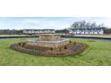 Stone fountain with landscaping at the entrance to the new community at 321 Sound Cir, Stockbridge, GA 30281
