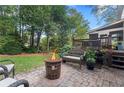 Charming backyard with a brick patio, seating, and a cozy fire pit at 3609 Meadow Chase Dr, Marietta, GA 30062