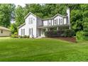 This well-maintained two-story home features mature landscaping and a inviting covered front porch at 361 Princeton Way, Lawrenceville, GA 30044