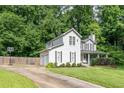 Gray two-story home with attached garage, basketball court, lush landscaping, and covered front porch at 361 Princeton Way, Lawrenceville, GA 30044