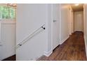 Hallway featuring wood flooring and white doors, with a view of the home's entrance at 3992 Joshua Ln, Douglasville, GA 30135