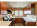 Well-equipped kitchen featuring wood cabinets, stainless steel sink, and efficient appliances at 879 Sylvan Sw Pl, Atlanta, GA 30310