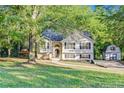 Quaint home with a lush front yard, a charming gazebo, and a storage shed at 733 Wesley Chapel Rd, Villa Rica, GA 30180