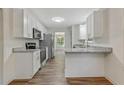 Modern kitchen with white cabinets, granite countertops, and stainless steel appliances at 733 Wesley Chapel Rd, Villa Rica, GA 30180