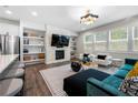 Bright open-concept living space with a fireplace, built-in shelves, and modern furnishings at 774 Belrose Dr, Smyrna, GA 30080