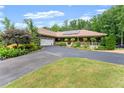 Charming home featuring an attached two-car garage, a welcoming front porch, and mature landscaping at 1572 Azalea Dr, Lawrenceville, GA 30043