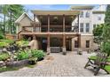 Spacious backyard featuring an upper deck with an outdoor lounge area, waterfall, and brick patio at 32 Pullman Trl, Acworth, GA 30101