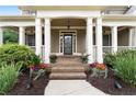 Inviting front entrance with brick steps, decorative planters, and a covered porch with columns at 32 Pullman Trl, Acworth, GA 30101
